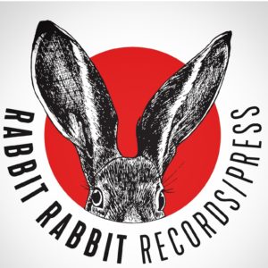 Rabbit rabbit records press logo with red circle and rabbit peaking through.