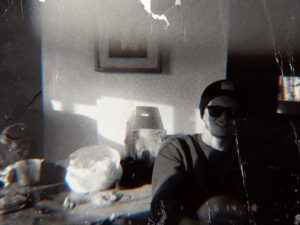 Torn black and white photo of a person.