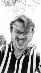 Black and white picture of man with glasses in warped picture.