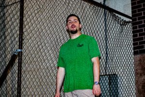 Man in green shirt with mouth open.