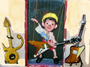 Pinnochio puppet with guitar.