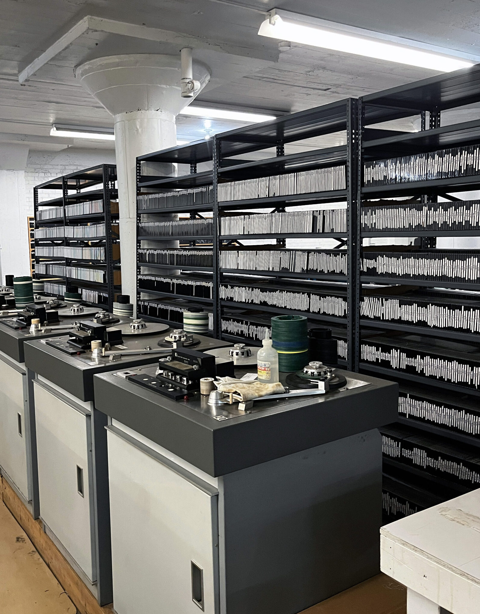 Tens of thousands of cassette master discs line the shelves of the production floor