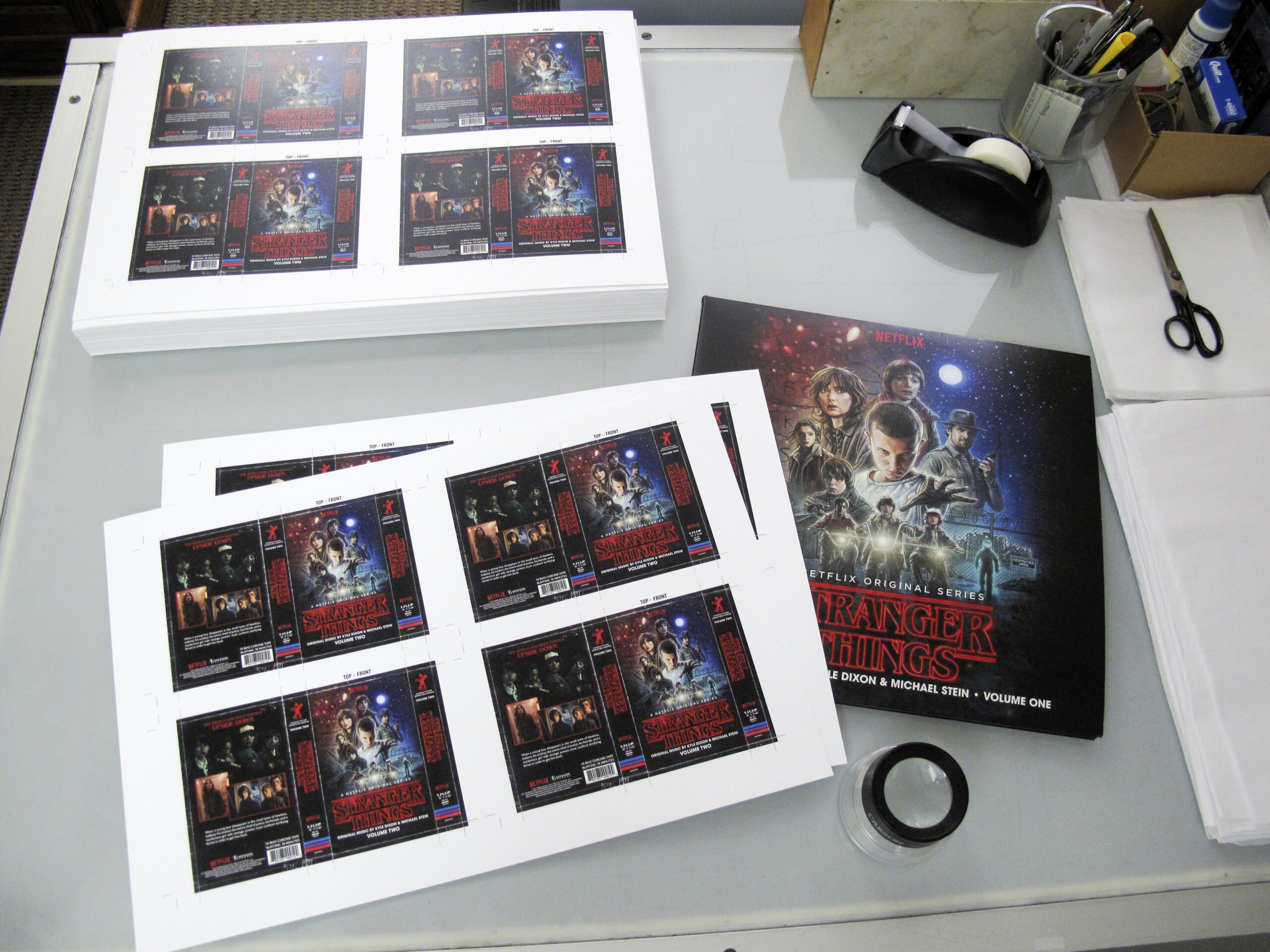 Stranger Things cassette tape and vinyl record laying on a table