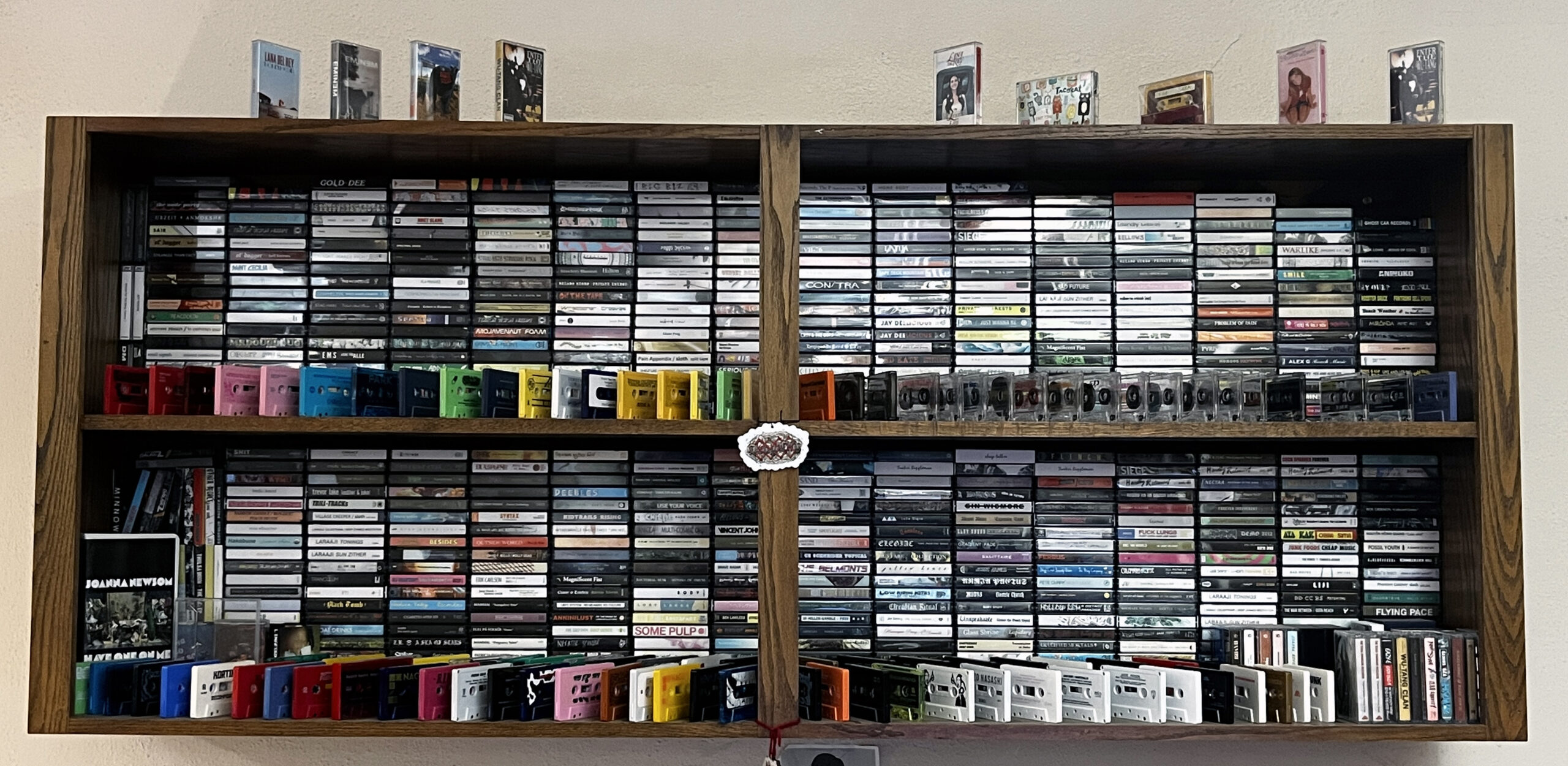 a shelf filled with various cassette tapes