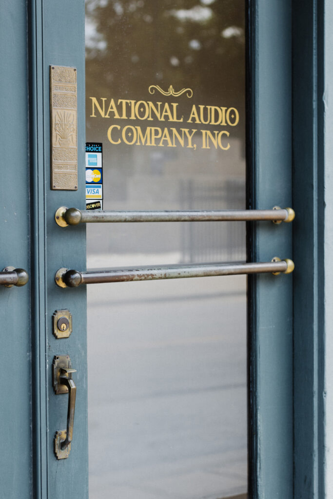 the vintage green and brass front door of National Audio Company